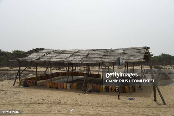 Jerrycans are used to define the periphery of a thatched mosque used by oil thieves tapping the Nigerian National Petroleum Company pipelines at the...