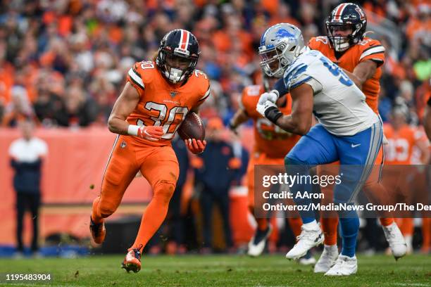 Phillip Lindsay of the Denver Broncos runs against the Detroit Lions during the third quarter on Sunday, December 22, 2019.