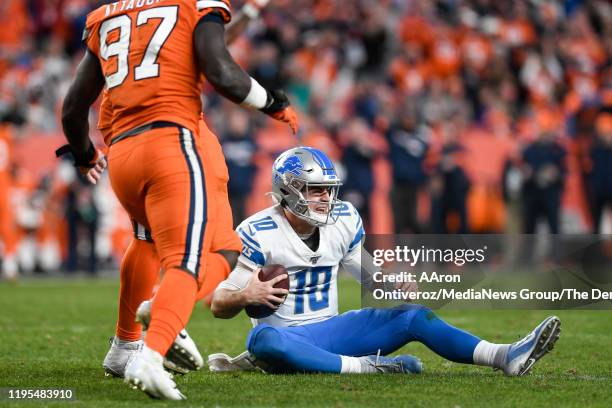 David Blough of the Detroit Lions sits on the ground after falling as he tried to rush out of the pocket against the Denver Broncos during the fourth...