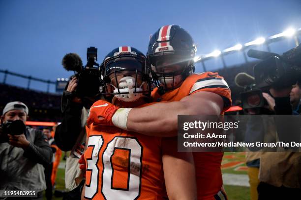 Phillip Lindsay of the Denver Broncos celebrates his rushing touchdown against the Detroit Lions with Andrew Beck during the fourth quarter of...