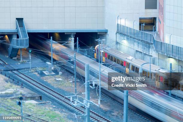 looking down on a train leaving the train station and a stationary train - ipswich queensland stock-fotos und bilder