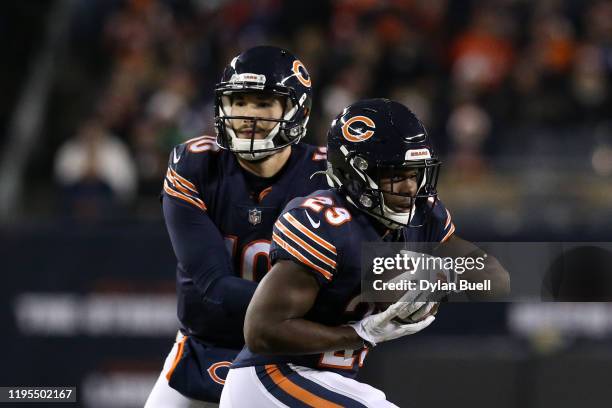 Quarterback Mitchell Trubisky of the Chicago Bears hands off the ball to teammate running back Tarik Cohen as they take on the Kansas City Chiefs in...