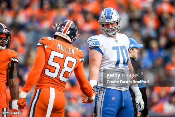 Von Miller of the Denver Broncos greets Dan Skipper of the Detroit Lions on the field during a game at Empower Field on December 22, 2019 in Denver,...