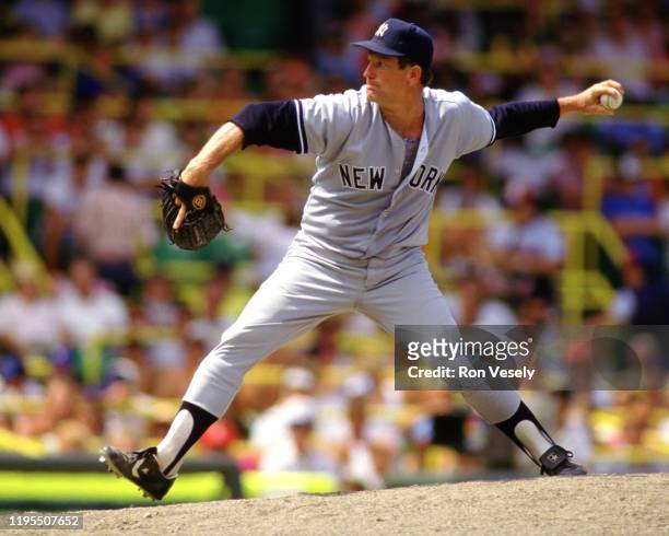 Tommy John of the New York Yankees pitches during an MLB game versus the Chicago White Sox during the 1987 season at Comiskey Park in Chicago,...