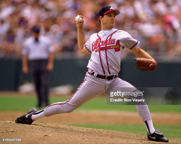 Greg Maddux of the Atlanta Braves pitches during an MLB game versus the Colorado Rockies at Coors Field in Denver, Colorado during the 1995 season.