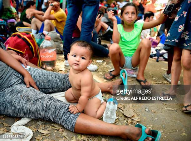 Baby and a girl remain among Central American migrants -mostly Hondurans heading in a caravan to the US- as they rest on their way from Ciudad...