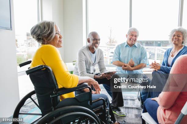 senior woman in wheelchair attending support group with other seniors - group therapy stock pictures, royalty-free photos & images