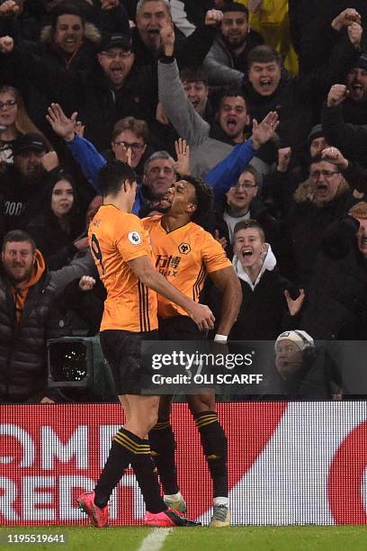Wolverhampton Wanderers' Mexican striker Raul Jimenez celebrates with Wolverhampton Wanderers' Spanish striker Adama Traore after he scores his...