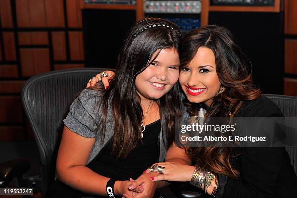 Actress/singer Demi Lovato and sister actress Madison De La Garza attend a Live Chat at Cambio Studios on July 21, 2011 in Hollywood, California.