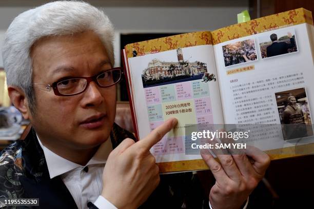 This photo taken on January 21, 2020 shows Taiwan-based fortune teller Tsai Shang-chi displaying his new book at his office in Taipei. - As the world...