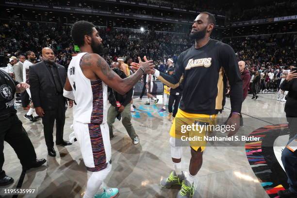 Kyrie Irving of the Brooklyn Nets and LeBron James of the Los Angeles Lakers hi-five after a game on January 23, 2020 at Barclays Center in Brooklyn,...