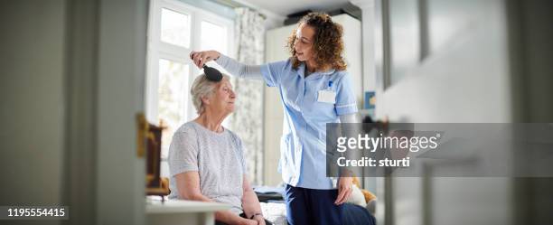 help in the morning - woman brushing hair stock pictures, royalty-free photos & images