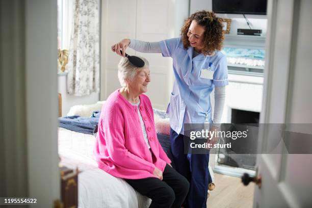 carer helping senior - brushing hair stock pictures, royalty-free photos & images