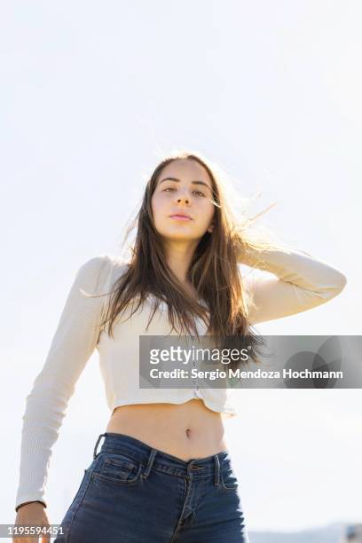 portrait of a young woman in mexico city, mexico - female navel ストックフォトと画像