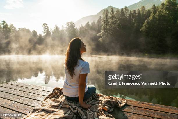 woman at alpine lake, engadin, switzerland. - passerella di legno foto e immagini stock