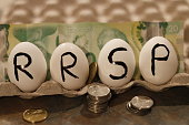The RRSP is a Canadian savings account that is tax deferred. The word RRSP wrote on eggs as a theme of nest egg or savings.