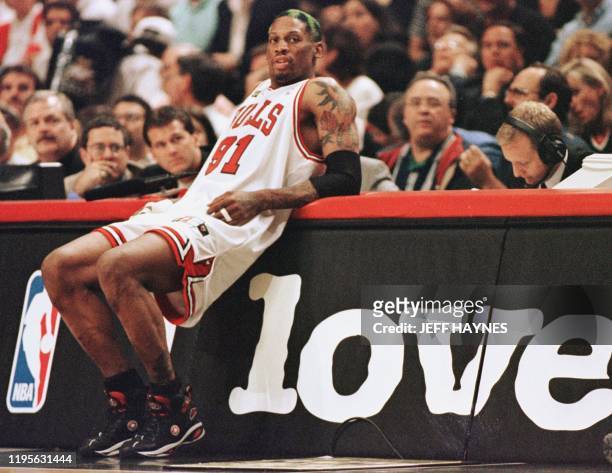 Dennis Rodman of the Chicago Bulls leans on the scorers table as he waits to come into the game against the Utah Jazz 10 June in game four of the NBA...