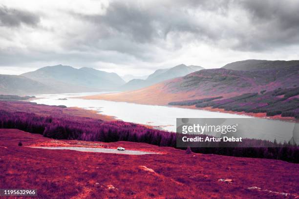 stunning infrared photography landscape of the highlands mountains in scotland. - color blindness stock pictures, royalty-free photos & images