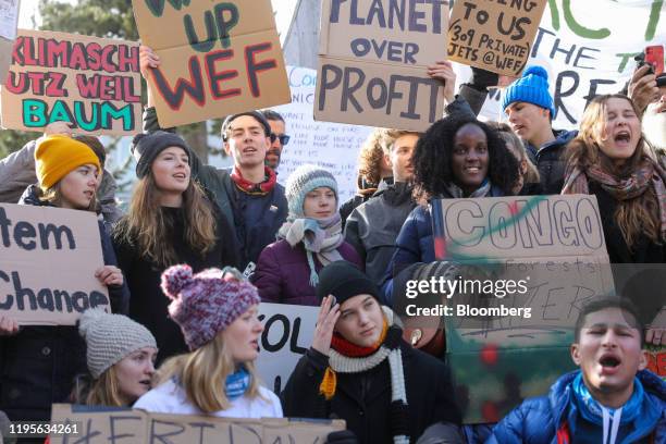 Climate activists Greta Thunberg, center, Vanessa Nakate, center right, Isabelle Axelsson, bottom third left, and Luisa Neubauer, center left, hold...