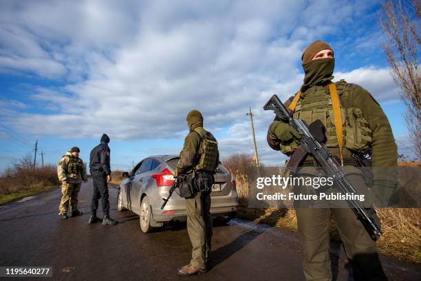 Servicemen stop a car during a joint patrolling mission of the territories close to the state border carried out by border guards of the Chop...