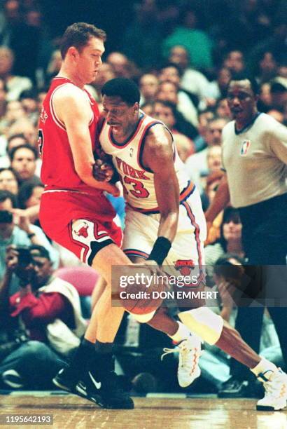 New York Knicks Patrick Ewing drives on Chicago Bulls Luc Longley during their conference semi-finals game 11 May at Madison Square Garden. The...