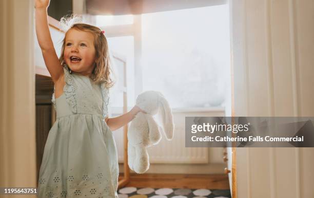 happy little girl and toy - free tiny girls stock-fotos und bilder