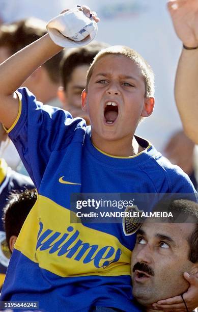 Boy, fan of the Argentine team Boca Juniros, cheers during his team's first goal against Vasco da Gama, of Brazil, during their Copa Mercosur game at...