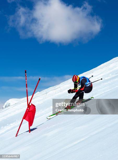 young adult alpine skier racing downhill - downhill skiing stock pictures, royalty-free photos & images