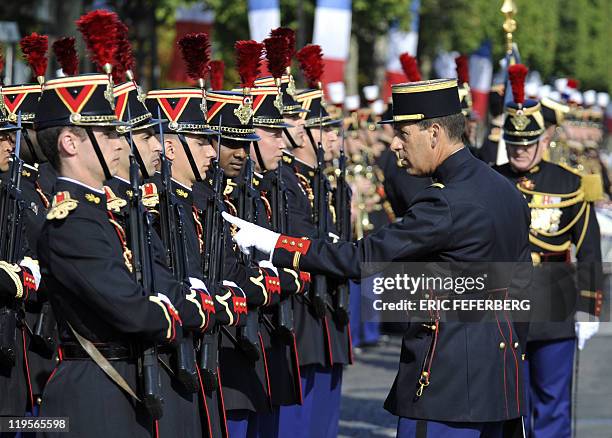 French soldiers from a Republican guards infantry regiment are standing to attention in front of an officer during the annual Bastille day parade on...