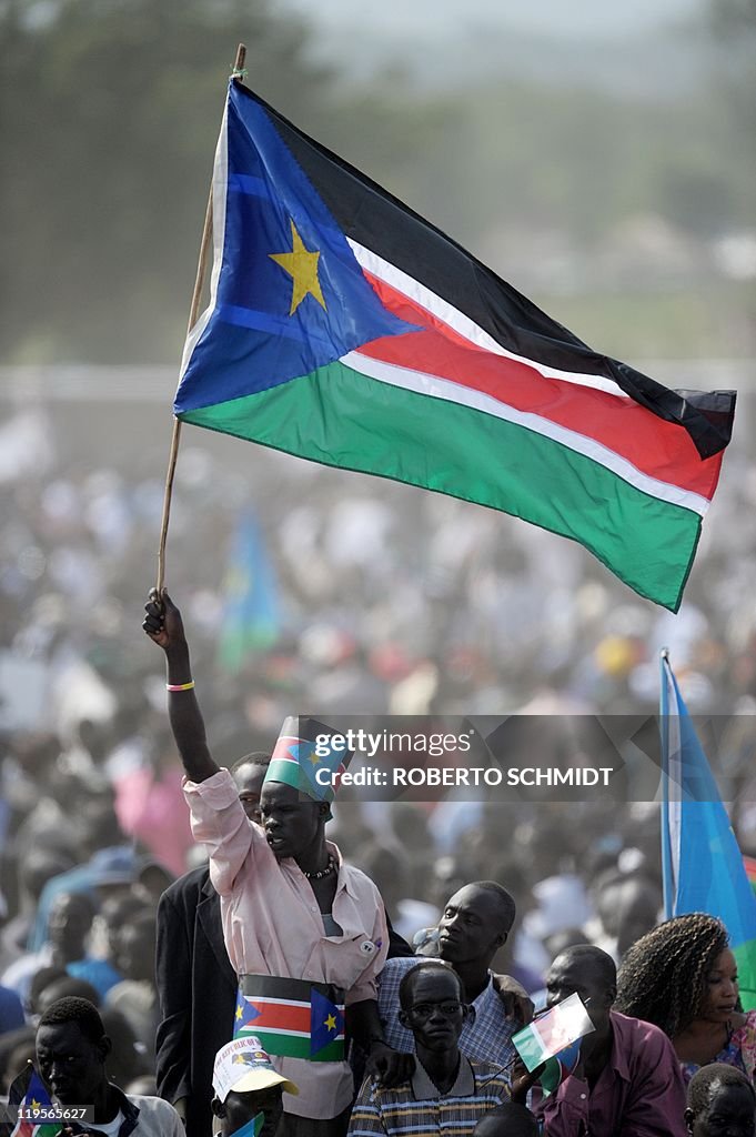 A Southern Sudanes man waves a Southern