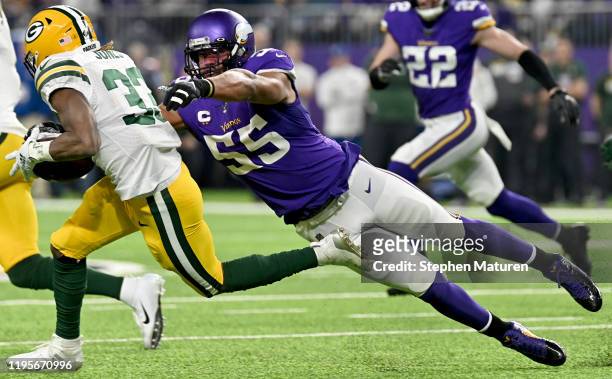 Outside linebacker Anthony Barr of the Minnesota Vikings tackles running back Aaron Jones of the Green Bay Packers to cause a fumble in the first...