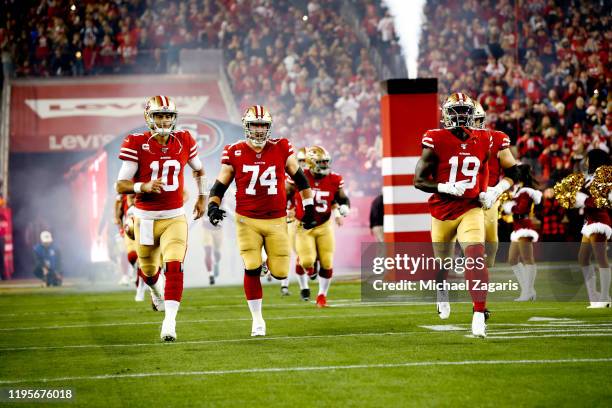 Jimmy Garoppolo, Joe Staley and Deebo Samuel of the San Francisco 49ers take the field prior to the game against the Los Angeles Rams at Levi's...