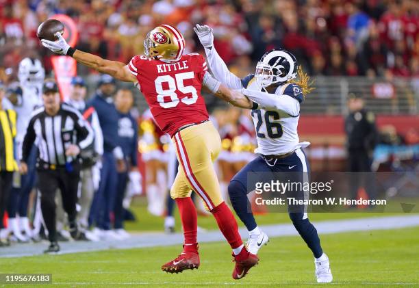 Marqui Christian of the Los Angeles Rams breaks up the pass to George Kittle of the San Francisco 49ers during the first half of an NFL football game...