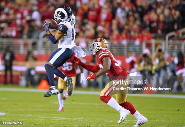 Robert Woods of the Los Angeles Rams catches a pass in front of Dre Greenlaw of the San Francisco 49ers durning the first half of an NFL football...