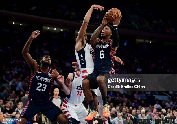 Elfrid Payton of the New York Knicks takes a shot past Troy Brown Jr. #6 of the Washington Wizards during the second half of their game at Madison...
