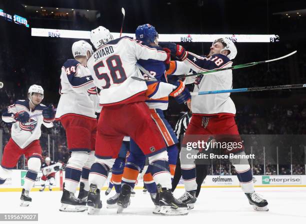 Anders Lee of the New York Islanders and Pierre-Luc Dubois of the Columbus Blue Jackets exchange pushes during the third period at NYCB Live's Nassau...