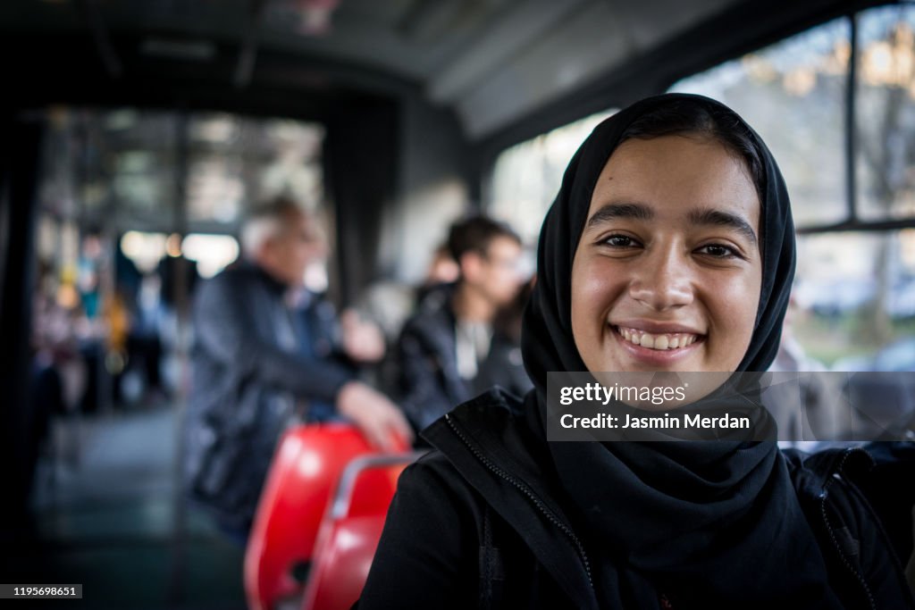 Portrait of Middle Eastern smiling girl in tram