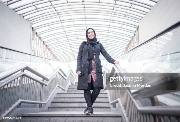 muslim girl standing on station - beautiful arabian girls stock-fotos und bilder