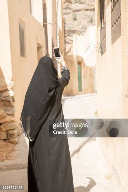 woman wearing abaya and sheila in oman - nikab stock pictures, royalty-free photos & images