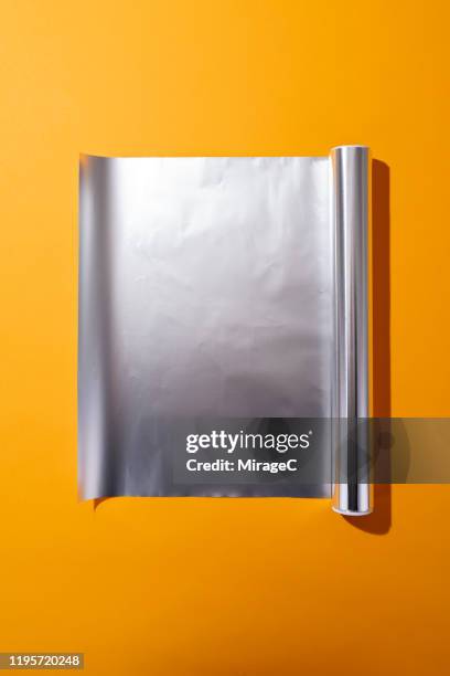 roll of opened aluminium foil - rolling fotografías e imágenes de stock
