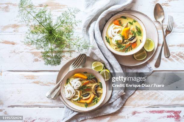 curried pumpkin and rice noodle soup for two - carrot stock photos et images de collection