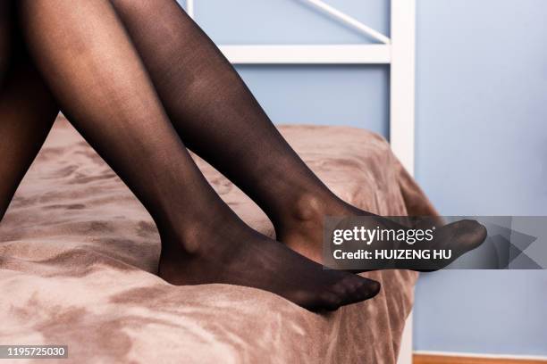 female legs in black stockings on the bed, style and fashion - black women in tights stock pictures, royalty-free photos & images