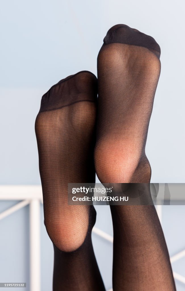 Female Feet In Black Stockings Closeup High-Res Stock Photo