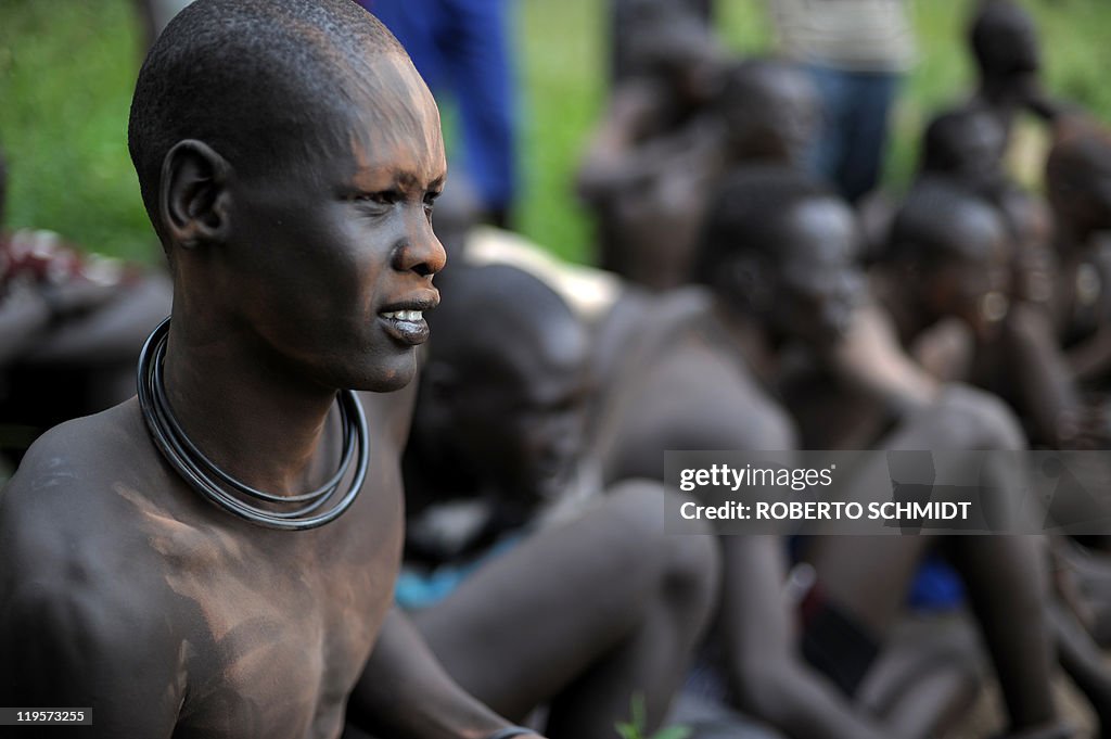 A South Sudanese man looks at members of