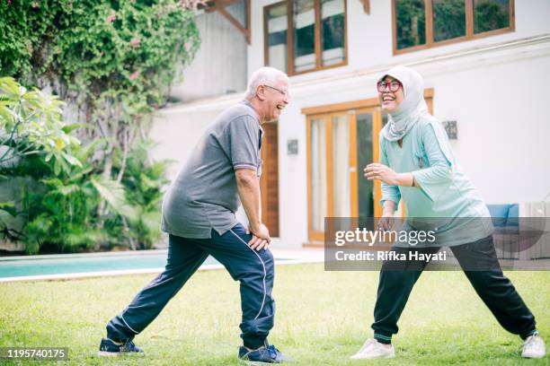 beautiful senior couple exercise together - malay lover stock pictures, royalty-free photos & images