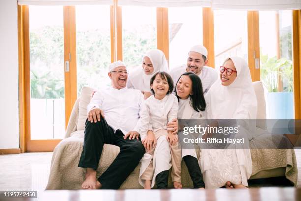 photo of lovely family celebrating hari raya aidilfitri - malay archipelago stock pictures, royalty-free photos & images