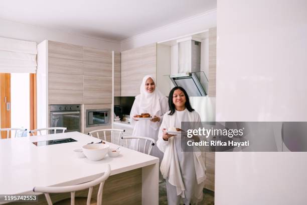 mother and daughter preparing food for hari raya aidilfitri - muslims prepare for eid in indonesia stock pictures, royalty-free photos & images