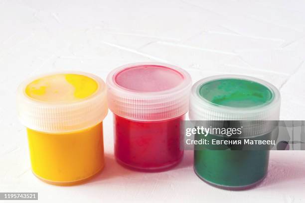 jars with multi-colored gouache or acrylic paints on a light white background. selective soft fokus. text copy space. - tube de peinture photos et images de collection