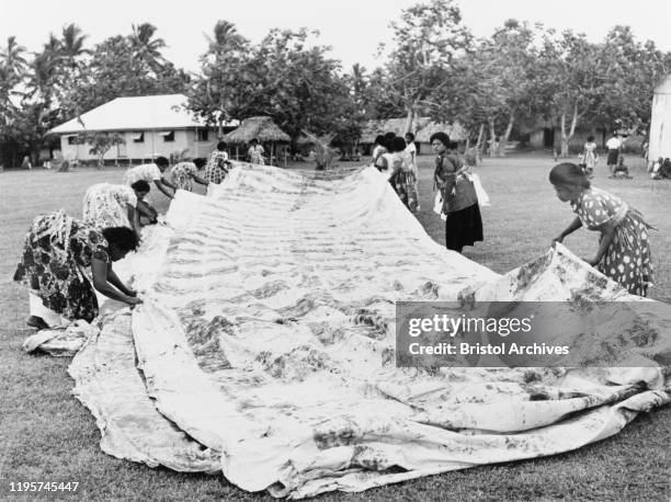 Fiji, Laying out a 'masi' clothA group of Fijian women lay out a finished 'masi' or 'tapa' cloth, made from the bark of the paper mulberry tree ....