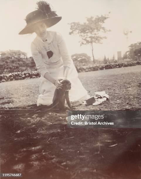 ZambiaNorthern Rhodesia, A lady, identified by one source as Princess Patricia, the Duke of Connaught's daughter, kneels on the ground to stroke a...